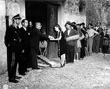 a woman receives bread after waiting in a bread line in Agata, Sicily