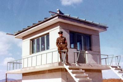 Photo of a North Korean soldier in front of the observation station at KPA #8, a North Korean checkpoint at the DMZ.