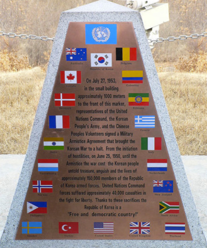 Photo of a monument that is dedicated to the armistice of the Korean War and it is bordered by all of the flags of the countries who participated in the United Nations peace keeping troops.