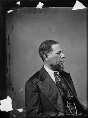 Image of Hiram R. Revels, sitting facing right
