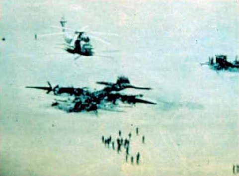 Image of a wrecked airplane and two downed helicopters